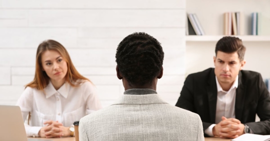black man being stared down by white coworkers