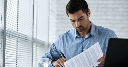 man looking over employment contract