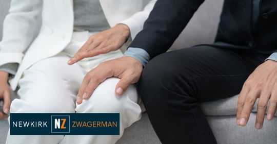 male employee inappropriately touching a woman's thighs