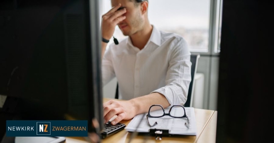 tired employee in front of a computer